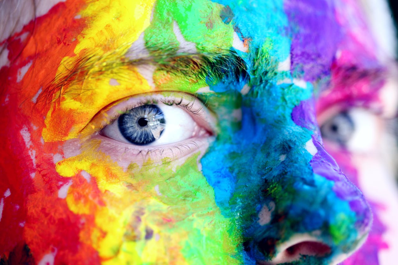 The Art of Drawing Readers In: Your attractive post title goes here Close-up of a person with colorful rainbow face paint, symbolizing LGBT pride and expression.